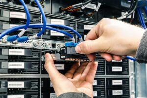 person removing a hard drive from a storage system